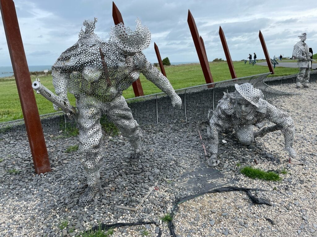 sculptures of soldiers on gold beach near the 360 cinema at arromanches